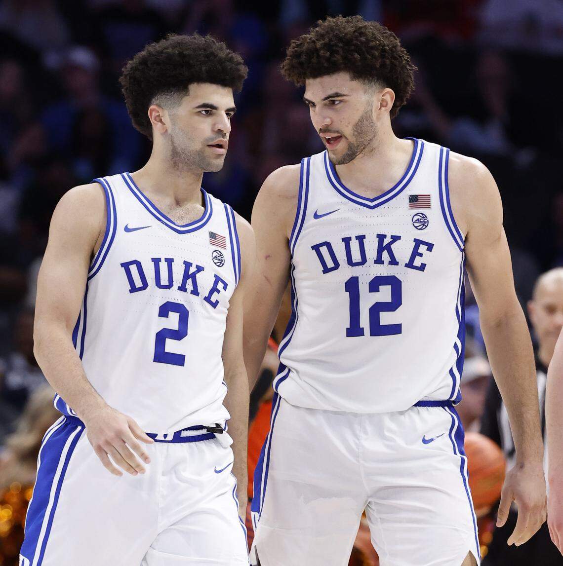 Duke’s Cameron Boozer (12) talks with his twin bother Cayden Boozer (2) during the second half of Duke’s 73-61 victory over Clemson in the semifinals of the 2026 ACC Men’s Basketball Tournament at the Spectrum Center in Charlotte, N.C., Friday, March 13, 2026.