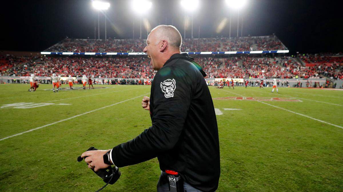 N.C. State head coach Dave Doeren celebrates as time runs out in the Wolfpack’s 20-6 victory over Miami at Carter-Finley Stadium in Raleigh, N.C., Saturday, Nov. 4, 2023. The victory makes Doeren the Pack’s the winningest coach in N.C. State history.