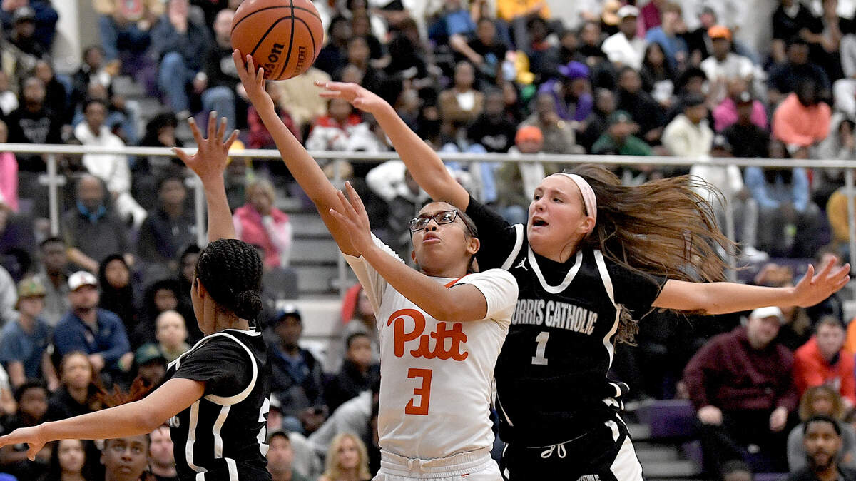 North Pitt’s Zamaryea Jones (3) attempts the layup against Morris Catholic’s Ashley Labeach (1) during the first half of their game in the John Wall Holiday Invitational. The North Pitt Panthers and the Morris Catholic Crusaders met in a final of the John Wall Holiday Invitational in Raleigh, N.C. on December 30, 2023.