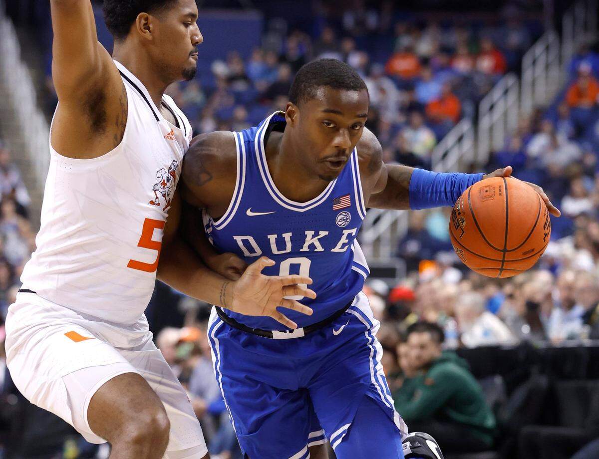 Duke’s Dariq Whitehead (0) drives around Miami’s Harlond Beverly (5) during the second half of Duke’s 85-78 victory over Miami in the semifinals of the ACC Men’s Basketball Tournament in Greensboro, N.C., Friday, March 10, 2023.