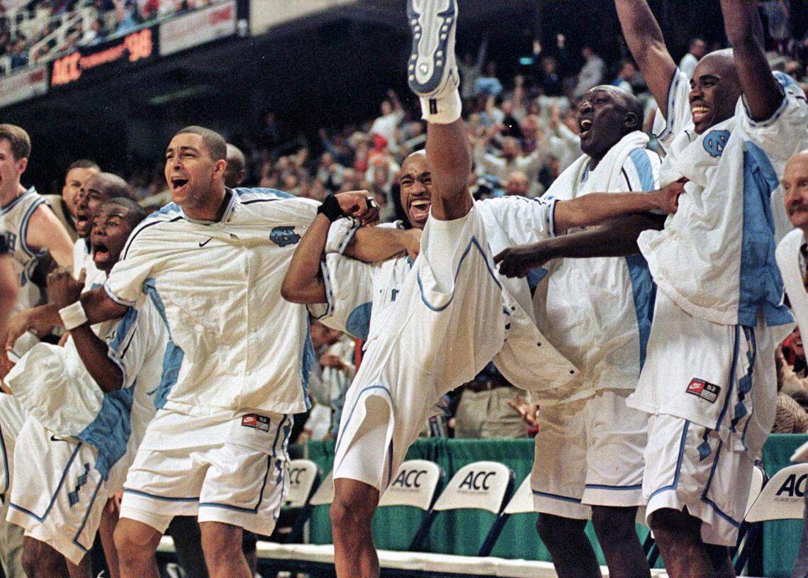 NCSU-UNC7.SP.030698.CCS. --(L-R)Shammond Williams, Ademola Okulaja, Vince Cater, Mahktar Ndiaye, and Atawn Jamison celebrate their victory over NC State during the Quarterfinals of the ACC Tournament on Friday