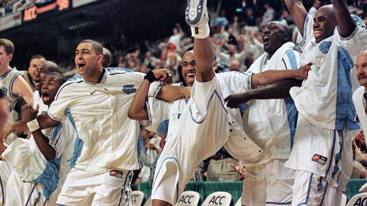 From left: Shammond Williams, Ademola Okulaja, Vince Cater, Mahktar Ndiaye, and Atawn Jamison celebrate their victory over NC State during the Quarterfinals of the ACC Tournament in 1998.