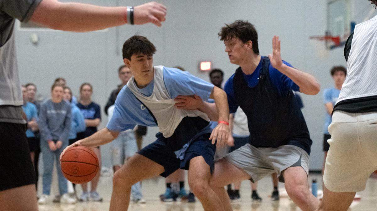 DTH staffer Aidan Lockhart dribbles the ball during the rivarly basketball game against The Chronicle in Brodie Recreation Center on Saturday, Jan. 24, 2025. DTH beat The Chronicle 2-1.