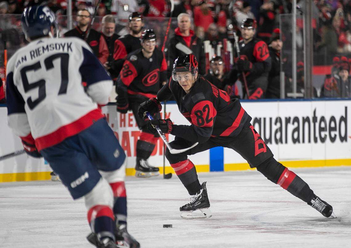 Carolina Hurricanes’ Jesperi Kotkaniemi (82) moves the puck in the third period against Washington’s Trevor Van Riemsdyk (57) during the Stadium Series game on Saturday, February 18, 2022 at Carter-Finley Stadium in Raleigh, N.C.