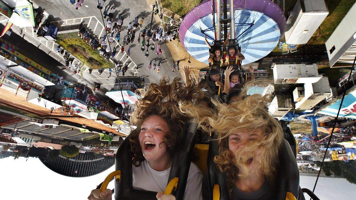 Courtney Stegall,12, left and pal Scarlett Harris,13 ride the Ring of Fire at the North Carolina State Fair Thursday Oct.18, 2007. The girls were visiting the fair from Cornerstone Christian School in Roanoke Rapids. Morning showers made way for a hot steamy afternoon the sixth day of the fair.