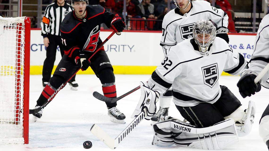 Los Angeles Kings goaltender Jonathan Quick (32) deflects a shot with Carolina Hurricanes’ Jesper Fast (71) and \teammate Sean Durzi (50) looking on during the second period of an NHL hockey game in Raleigh, N.C., Saturday, Dec. 18, 2021. (AP Photo/Karl B DeBlaker)
