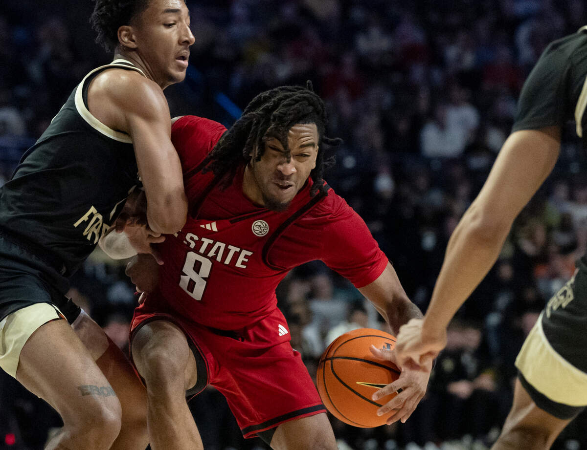N.C. State’s Jayden Taylor drives between Wake Forest’s Juke Harris and Hunter Sallis during the second half of the Wolfpack’s 77-59 loss on Saturday, Jan. 4, 2025, at Lawrence Joel Veterans Memorial Coliseum in Winston-Salem, N.C.