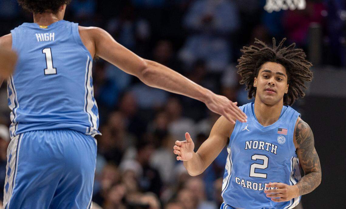 North Carolina’s Zayden High (1) congratulates teammate Elliot Cadeau (2) after a basket in the second half against Oklahoma on Wednesday, December 20, 2023 at the Spectrum Center in Charlotte, N.C.