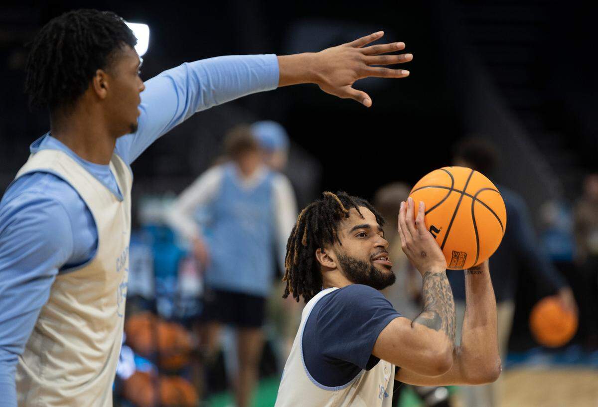 North Carolina’s Harrison Ingram (55) tries to distract teammate R.J. Davis (4) as he works on his three-point shot during their practice on Wednesday, March 20, 2024 as they prepare for the NCAA Tournament at Spectrum Center in Charlotte, N.C.