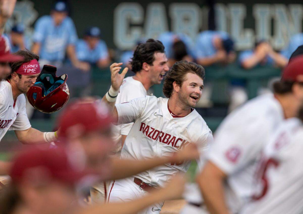 Arkansas Peyton Stovall (10) and his teammate celebrate following a single by Brady Slavens that scored the game winning run, giving the Razorback a 4-3 victory over North Carolina and clinching the NCAA Super Regional series on Sunday, June 12, 2022 at Boshamer Stadium in Chapel Hill, N.C.