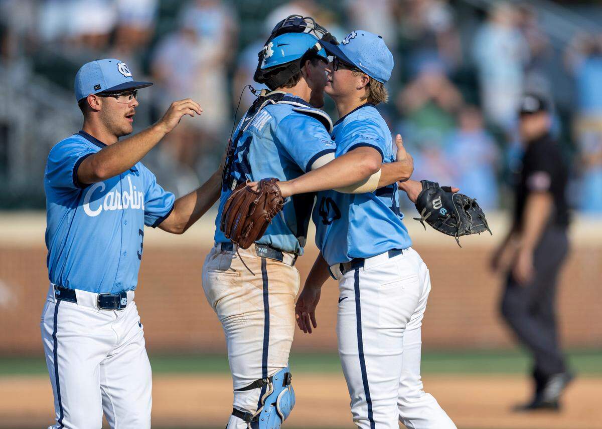 North Carolina closing pitcher Walker McDuffie (40) embraces Luke Stevenson (44) following the last out in the Tar Heels’ 14-4 victory over Oklahoma in Game 7 of the NCAA Chapel Hill Regional on Monday, June 2, 2025 at Boshamer Stadium in Chapel Hill, N.C.