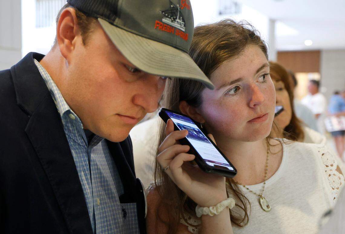John Brooks and his cousin Johnna Brooks, both Ph.D. students at N.C. State, listened to a press conference in the Legislative Building on June 24. It was held to voice opposition to legislation that would have banned shrimp trawling in North Carolina’s sounds.