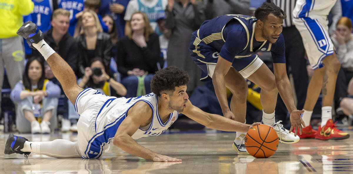 Duke guard Cayden Boozer (2) dives after a loose ball with Georgia Tech guard Lamar Washington (1) in the second half on Wednesday, December 31, 2025 at Cameron Indoor Stadium in Durham, N.C.