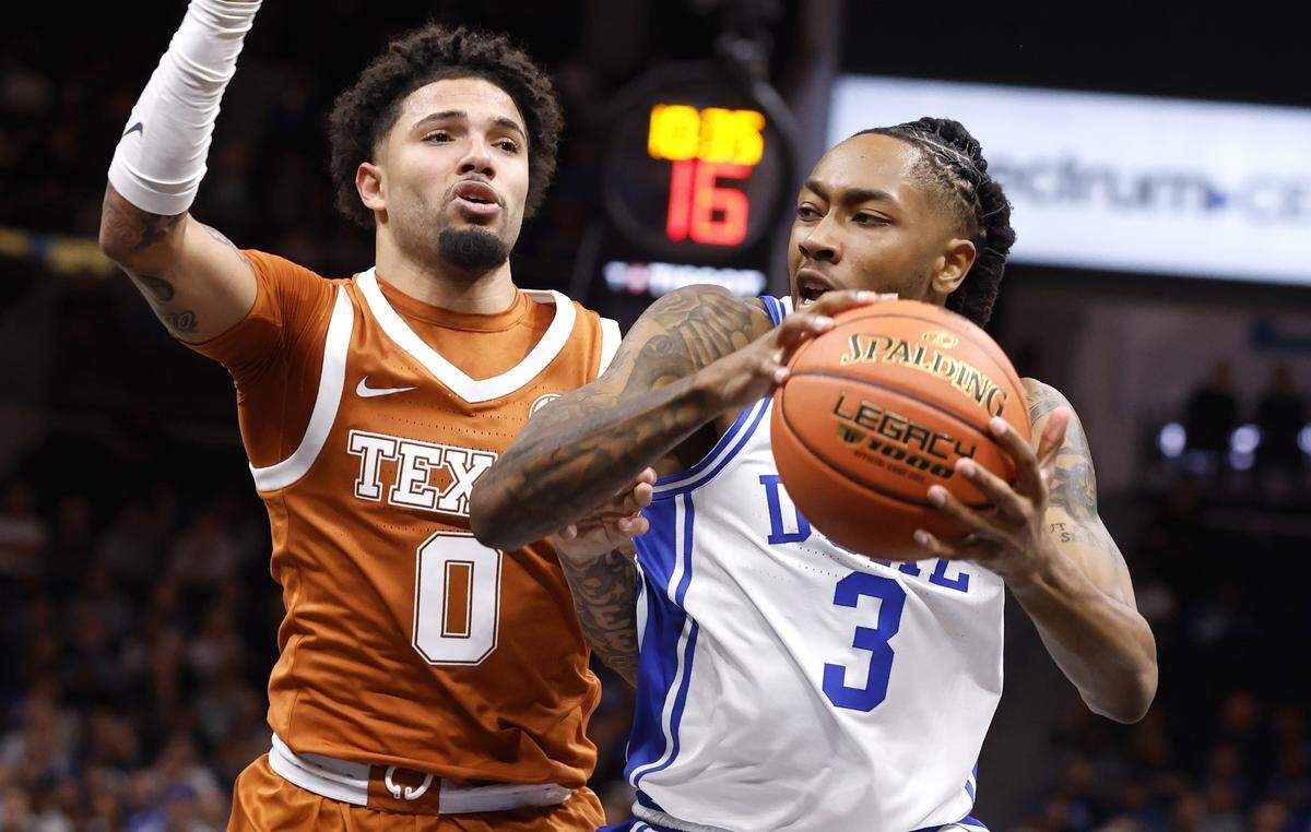 Duke’s Isaiah Evans (3) drives around Texas' Jordan Pope (0) during the first half of Duke’s game against Texas in the Dick Vitale Invitational at the Spectrum Center in Charlotte, N.C., Tuesday, Nov. 4, 2025.