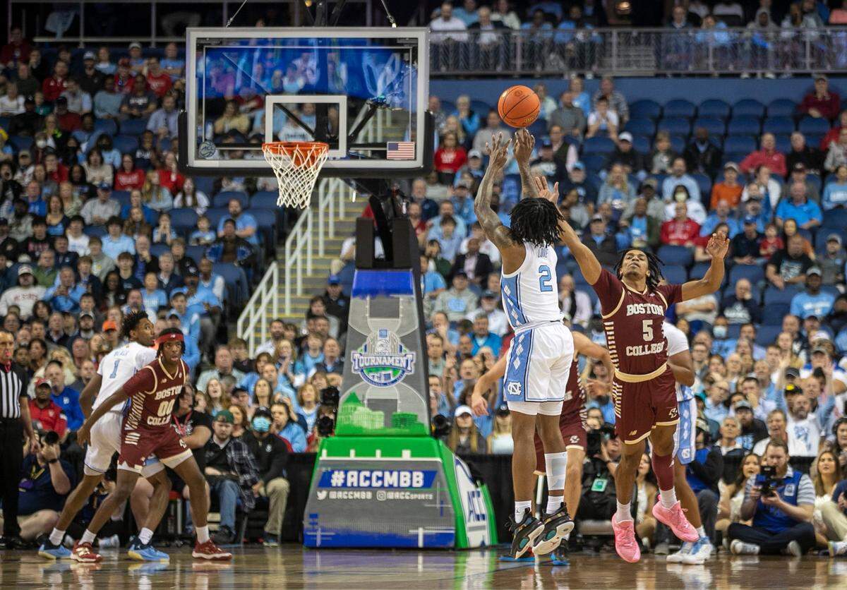 North Carolina’s Caleb Love (2) launches a three point shot against Boston College’s DeMarr Langford Jr. (5) during the first half in the second round of the ACC Tournament on Wednesday, March 8, 2023 at the Greensboro Coliseum in Greensboro, N.C.