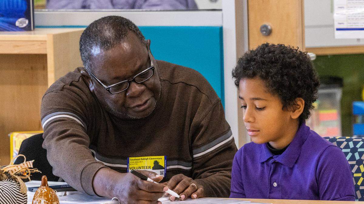 Volunteer tutor John Boyette and Wesley Volkel, 9, take part in the new WakeTogether tutoring program designed to help Wake County elementary students recover from pandemic learning loss Thursday, Nov. 17, 2022 at Southeast Raleigh Elementary School.