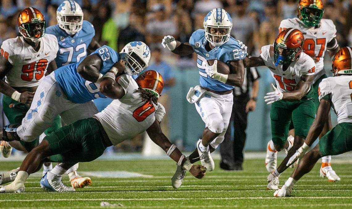 North Carolinas George Pettaway (23) breaks through the line for a 12-yard gain in the second quarter against Florida A&M on Saturday, August 27, 2022 at Kenan Stadium in Chapel Hill, N.C.