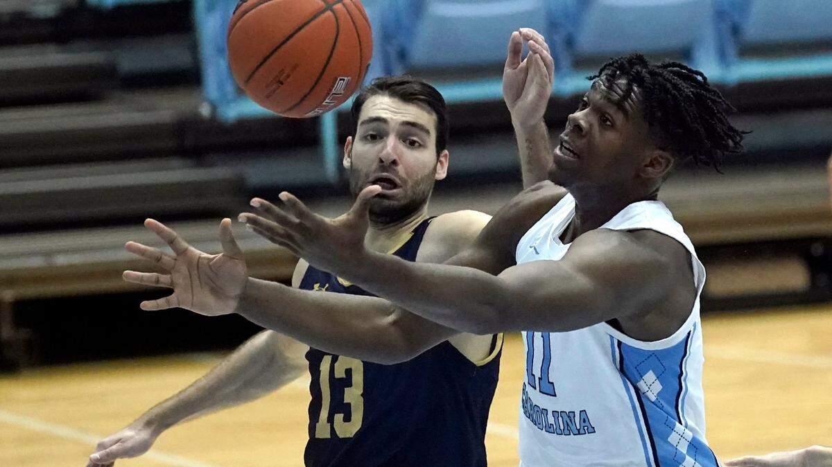 North Carolina forward Day’Ron Sharpe (11) drives to the basket while Notre Dame guard Nikola Djogo (13) defends during the first half of an NCAA college basketball game in Chapel Hill, N.C., Saturday, Jan. 2, 2021.