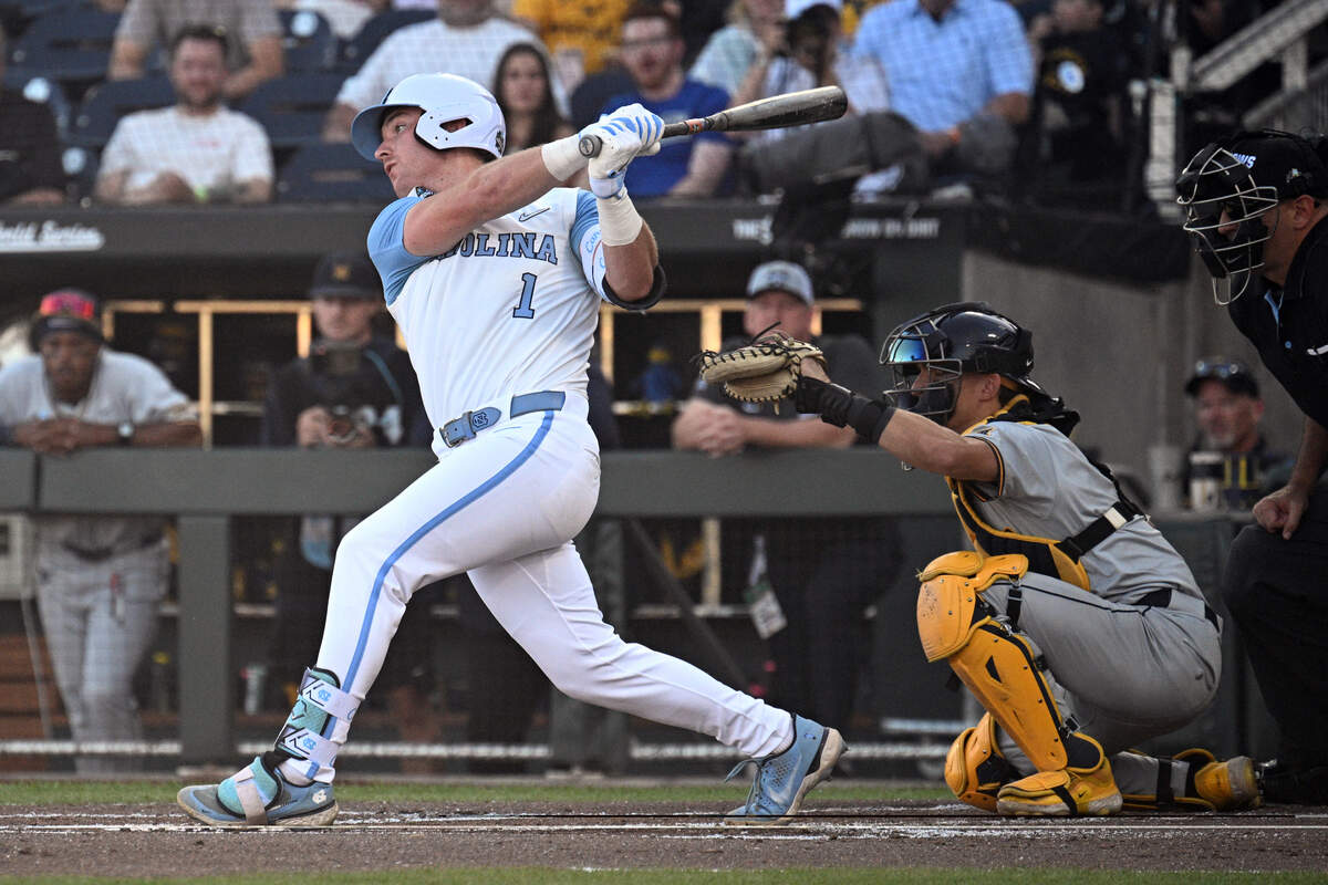 Jun 14, 2026; Omaha, NE, USA;  North Carolina Tar Heels third baseman Cooper Nicholson (1) drives in a run against the West Virginia Mountaineers during the second inning at Charles Schwab Field.