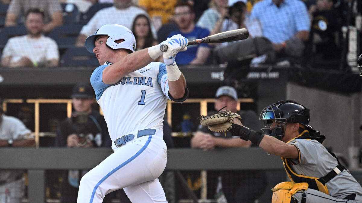 Jun 14, 2026; Omaha, NE, USA;  North Carolina Tar Heels third baseman Cooper Nicholson (1) drives in a run against the West Virginia Mountaineers during the second inning at Charles Schwab Field.