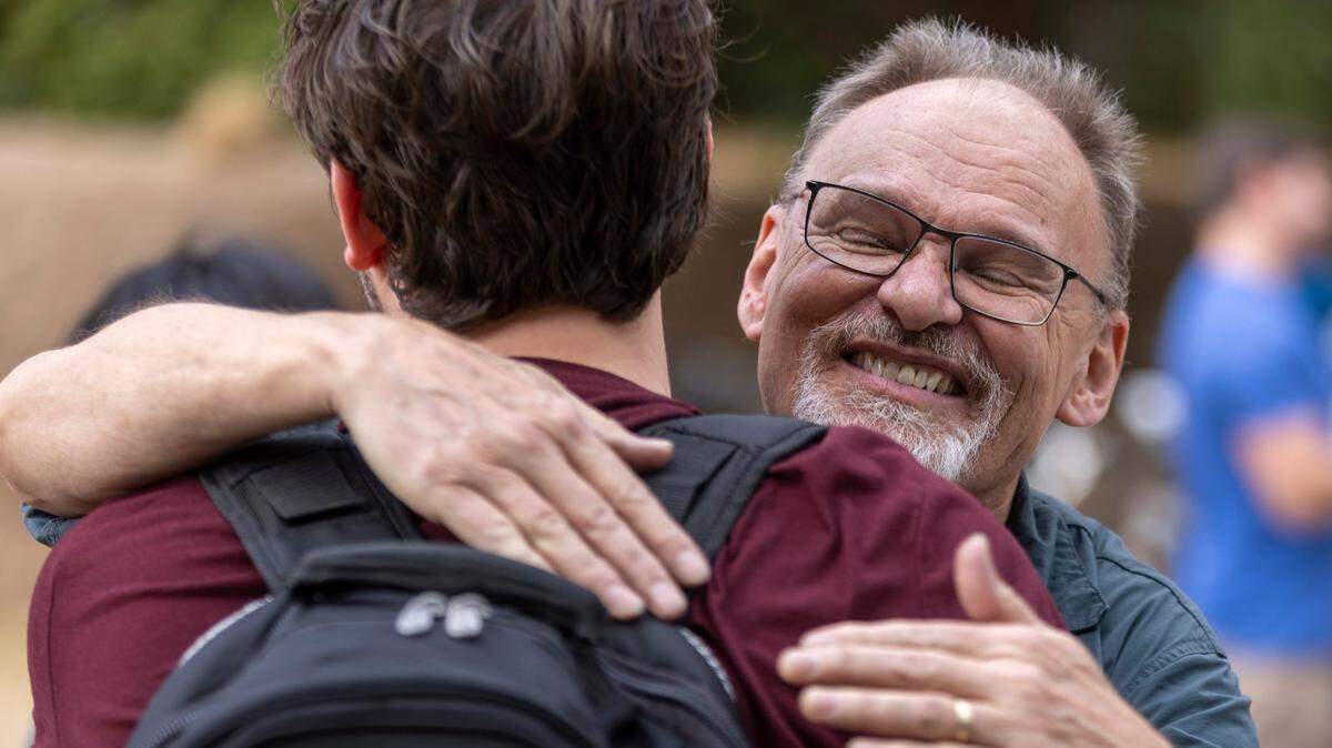 Dave Nelson hugs an N.C. State student during the weekly ‘Free Mom’ event at N.C. State’s Talley Student Union on Thursday, February 23, 2023 in Raleigh, N.C. ‘Free Mom” began three years ago when Nancy Nelson brought one cake and offered free hugs to students. The group has grown to more 70 volunteers serving snacks and hugs to more than 500 students each Thursday.
