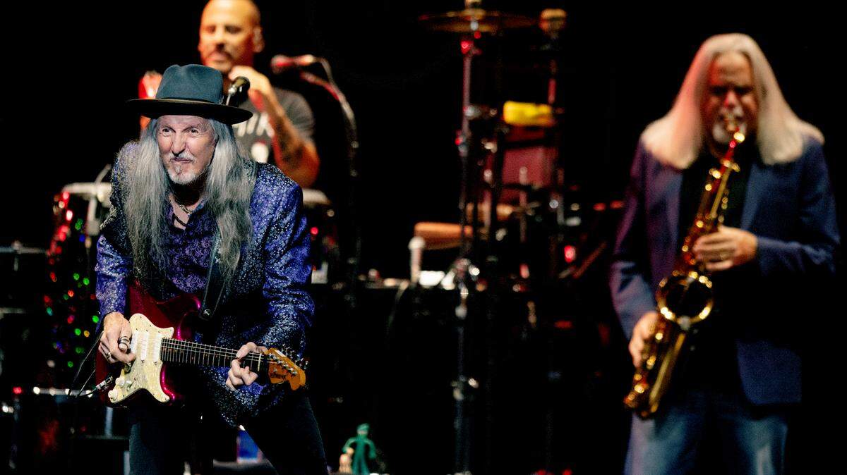 Patrick Simmons on guitar and Marc Russo on sax bring the crowd to its feet as The Doobie Brothers open for the Eagles on ‘The Long Goodbye’ Final Tour to Raleigh, N.C.’s PNC Arena, Thursday night, Nov. 9, 2023.