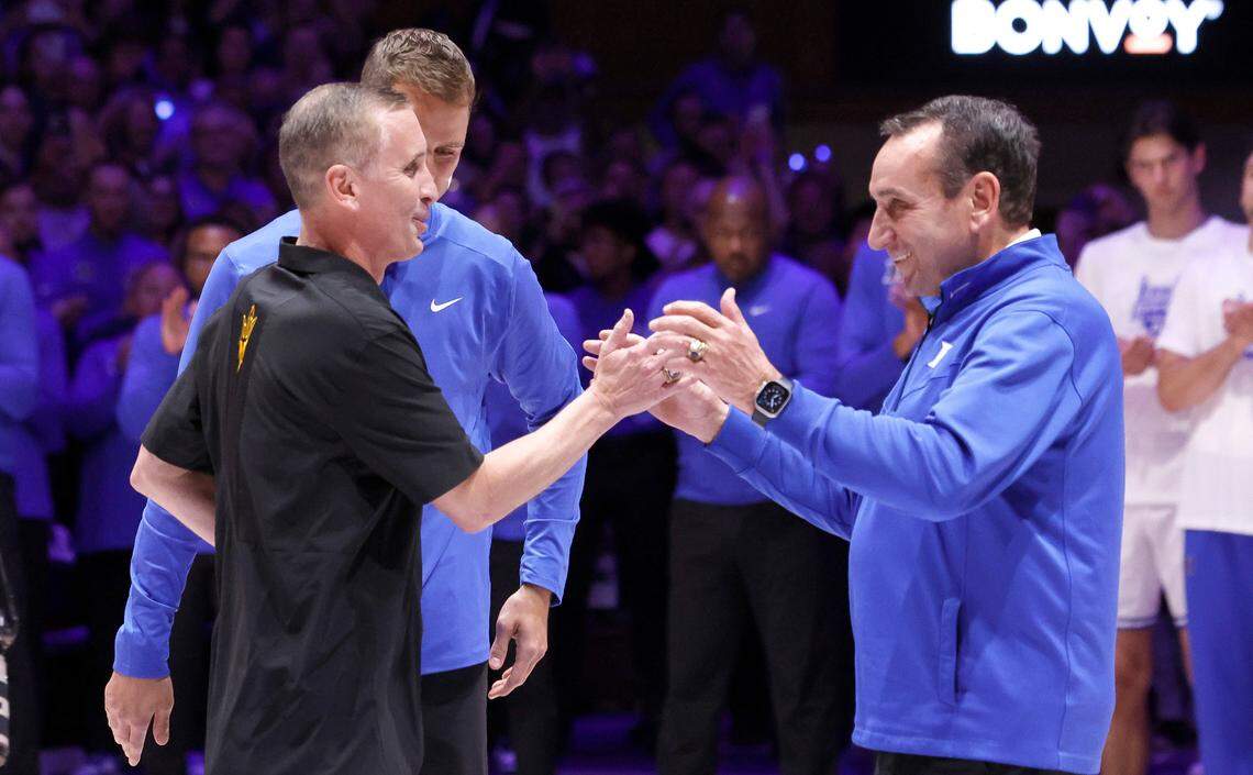 Former Duke head coach Mike Krzyzewski greets Arizona State’s head coach Bobby Hurley as Duke’s head coach Jon Scheyer watches during a ceremony before Duke’s game against Arizona State in the Brotherhood Run Charity Game at Cameron Indoor Stadium in Durham, N.C., Sunday, Oct. 27, 2024.