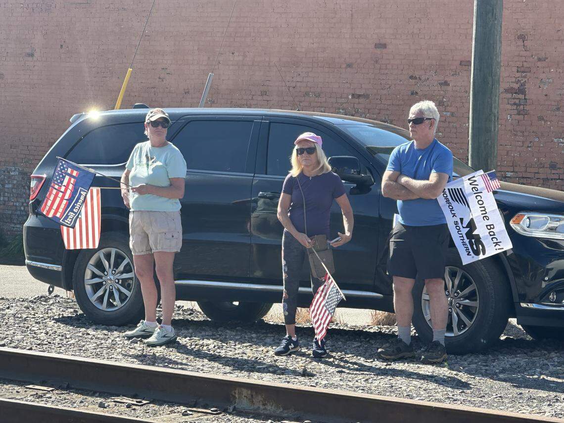 More than 200 people gathered along the tracks and outside the old train station in Old Fort on Saturday, April 18, 2026, to welcome the first Norfolk Southern train through town since the remnants of Hurricane Helene destroyed the tracks in September 2024.