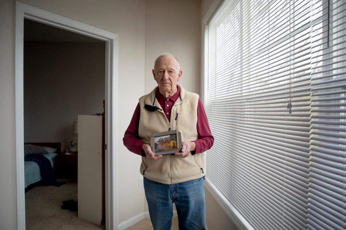 Albert Robinson holds a photograph of himself together with his late wife, on Tuesday, Mar. 2, 2021, in Raleigh, N.C.