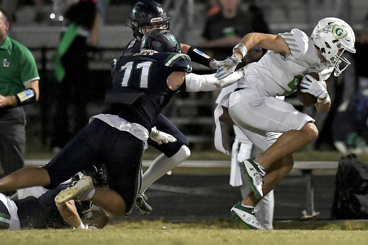 Cardinal Gibbons’ wide receiver Brayden Karras (9) rushes for yards along the sidelines against Leesville Road’s Christian Shaw (11) during the first half. The Leesville Road Pride and the Cardinal Gibbons Crusaders met in a conference football game in Raleigh, N.C. on November 1, 2024.