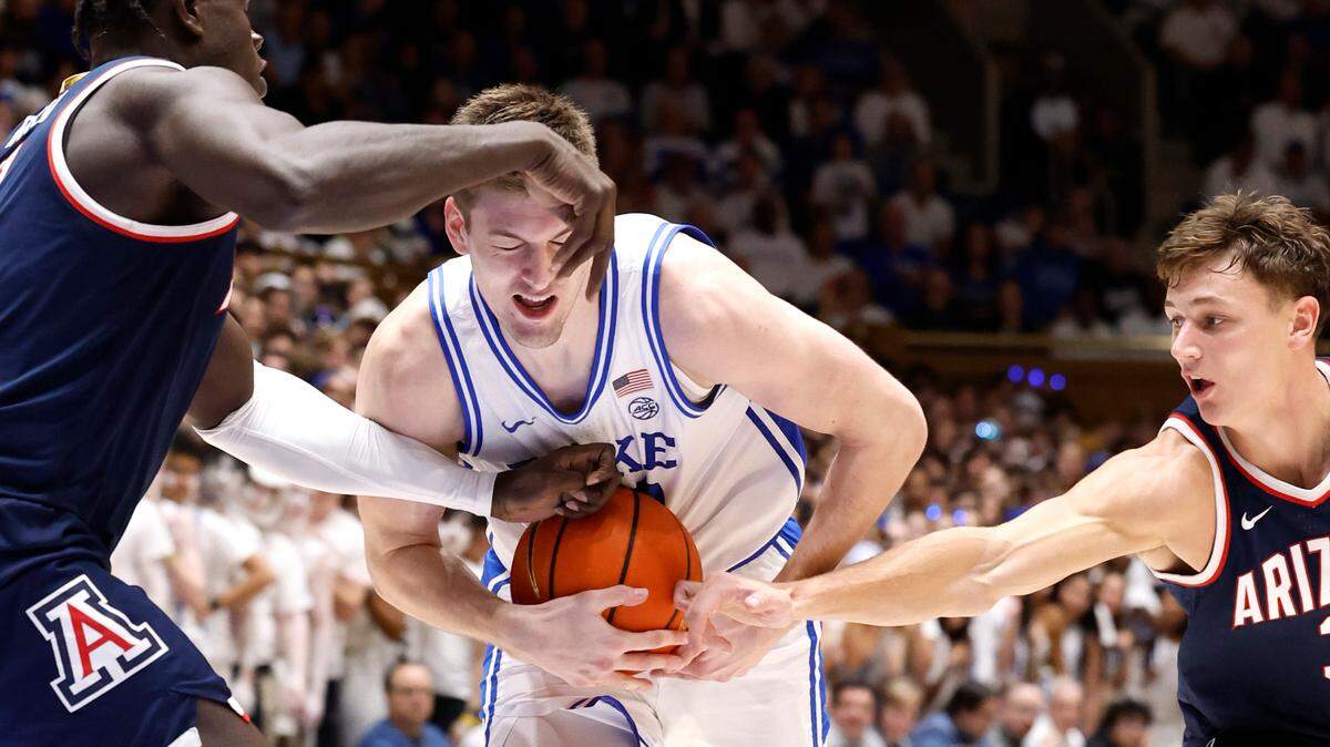 Duke’s Kyle Filipowski (30) drives between Arizona’s Oumar Ballo (11) and Pelle Larsson (3) during the second half of Arizona’s 78-73 victory over Duke at Cameron Indoor Stadium in Durham, N.C., Friday, Nov. 10, 2023.