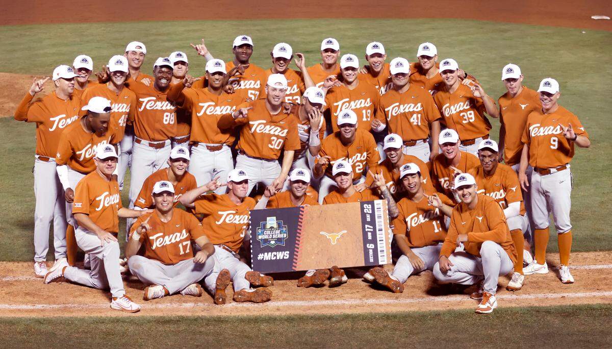 Texas players pose after Texas’ 11-1 victory over ECU to win the Greenville Super Regional at Clark-LeClair Stadium early Monday morning, June 13, 2022.