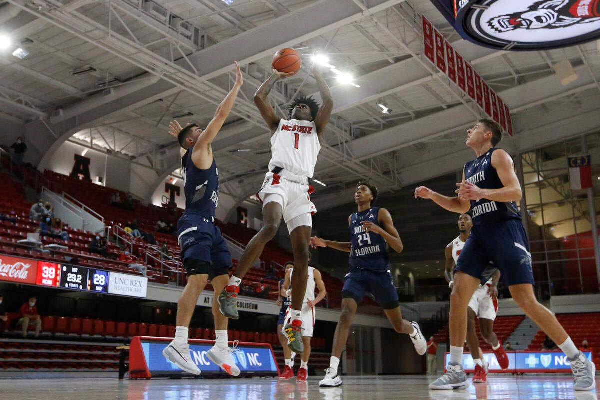 N.C. State’s Dereon Seabron (1) shoots as North Florida’s Jose Placer (15) defends during N.C. State’s 86-51 victory over North Florida in the Mako Medical Wolfpack Invitational at Reynolds Coliseum in Raleigh, N.C., Friday, Nov. 27, 2020.
