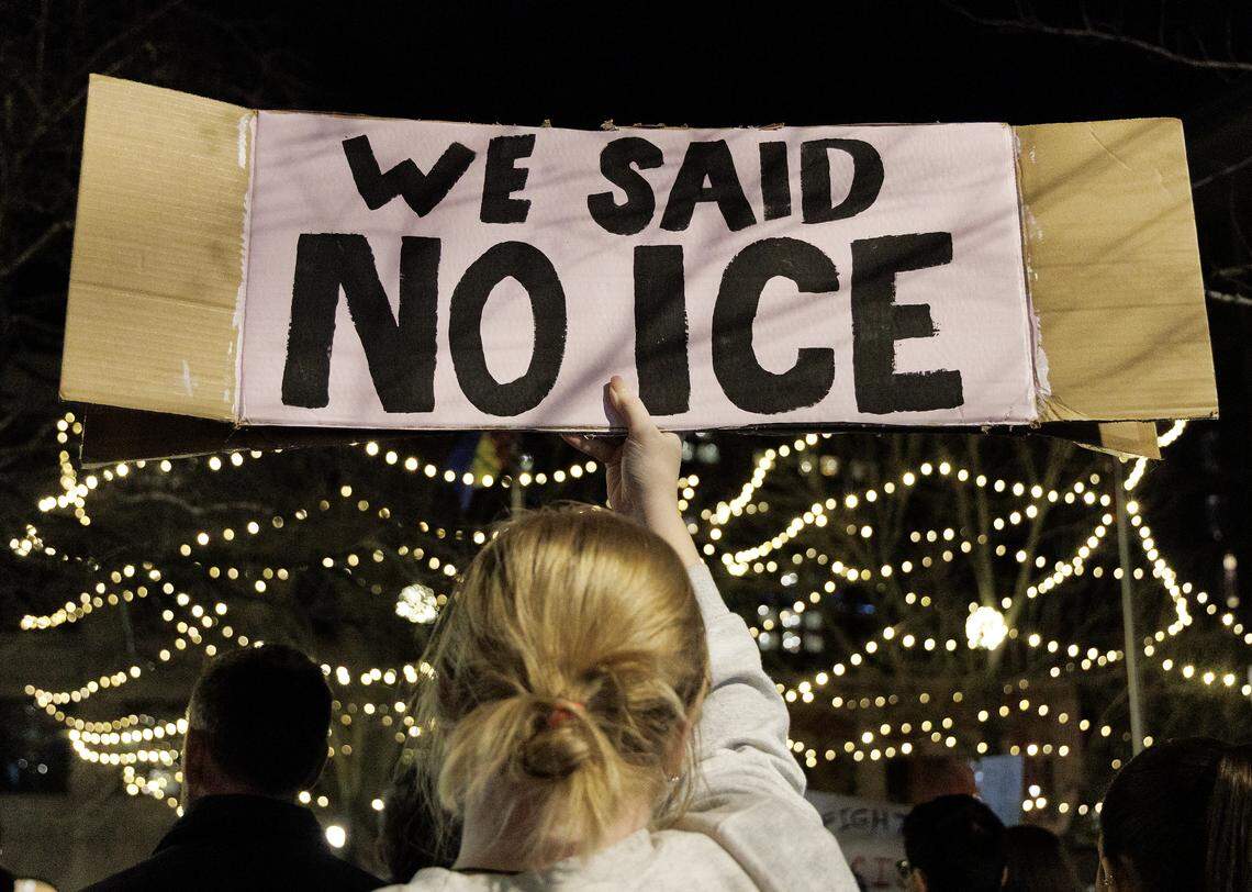 A person holds a sign during a protest in downtown Durham on Thursday, Jan. 8, 2026, held in response to Wednesday’s fatal shooting of Renee Nicole Good by a federal immigration agent in Minneapolis.