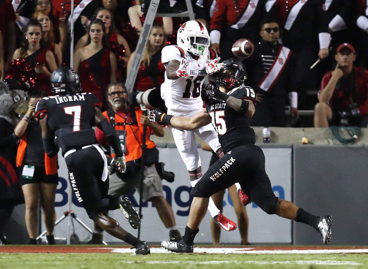 N.C. State’s C.J. Hart (15) breaks up the pass intended for Ball State’s Hassan Littles (16) that would be intercepted by Chris Ingram (7) during the second half of N.C. State’s 34-23 victory over Ball State at Carter-Finley Stadium in Raleigh, N.C. Saturday, Sept. 21, 2019.