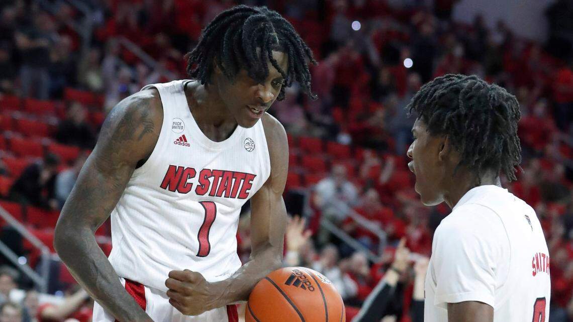 N.C. State’s Dereon Seabron (1) and Terquavion Smith (0) celebrate after Seabron made the basket in the fourth overtime during N.C. States 104-100 victory over Nebraska in four overtimes at PNC Arena in Raleigh, N.C., Wednesday, December 1, 2021.