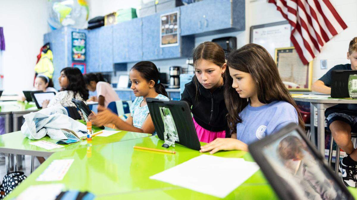 A 5th grade class sets up their iPads during the first day of school at Lake Norman Charter Middle School in Huntersville, N.C., on Thursday, August 10, 2023.