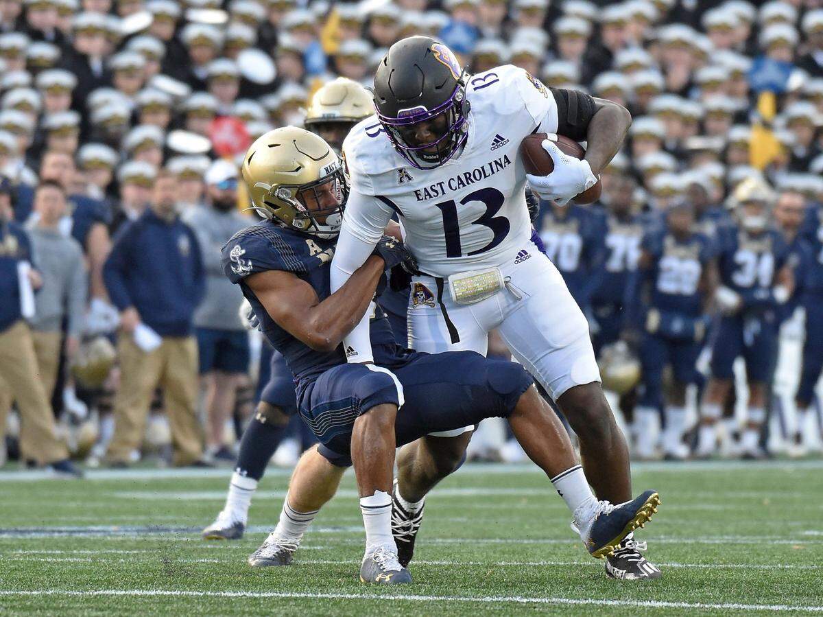 Navy’s Michael McMorris takes down East Carolina’s Ryan Jones after a catch in the first quarter Saturday in Annapolis, Maryland.