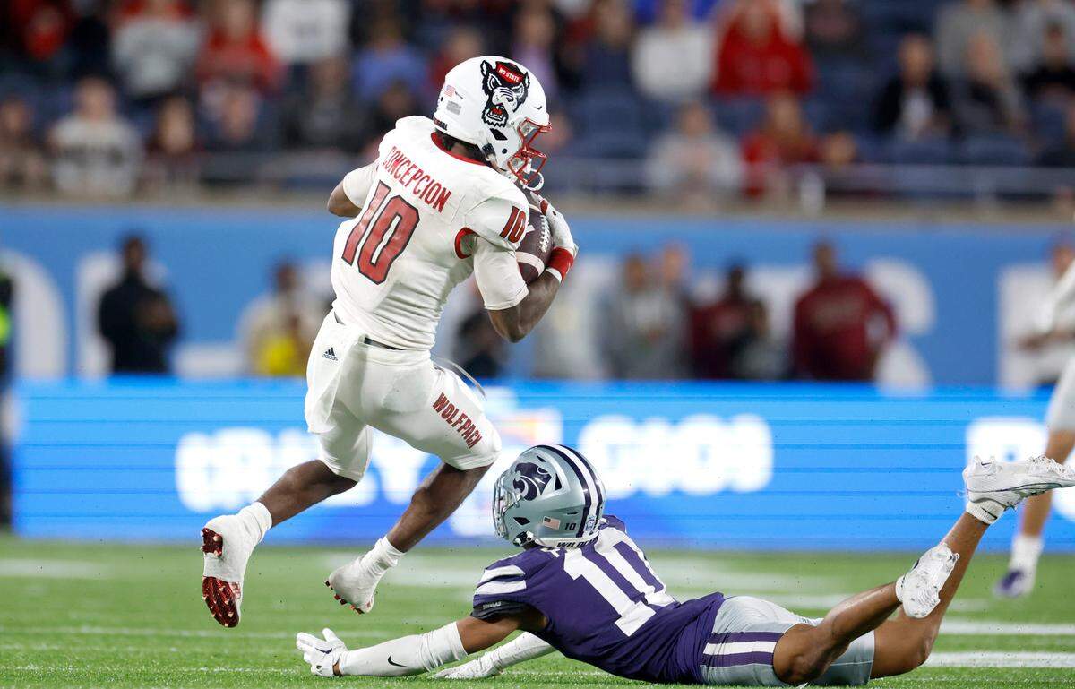 N.C. State wide receiver KC Concepcion (10) makes a 40-yard reception over Kansas State cornerback Jacob Parrish (10) during the second half of Kansas State’s 28-19 victory over N.C. State in the Pop-Tarts Bowl at Camping World Stadium in Orlando, Fla., Thursday, Dec. 28, 2023.