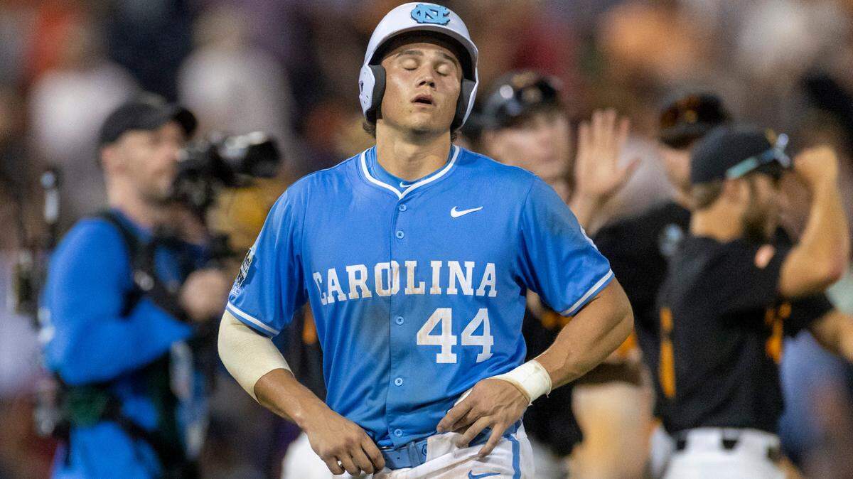 North Carolina catcher Luke Stevenson (44) reacts after teammate Jackson Van De Brake lined out to center field for the final out, and the Tennessee Volunteers celebrate their 6-1 victory over the Tar Heels, in game six of the College World Series on Sunday, June 16, 2024 at Charles Schwab Field in Omaha, Nebraska.
