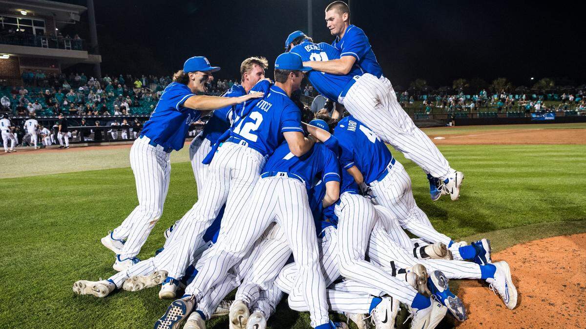 The Duke Blue Devils’ baseball team celebrates a 12-3 NCAA Tournament win over Coastal Carolina that clinched the Conway Regional championship on Monday night at Springs Brooks Stadium in Conway, S.C.