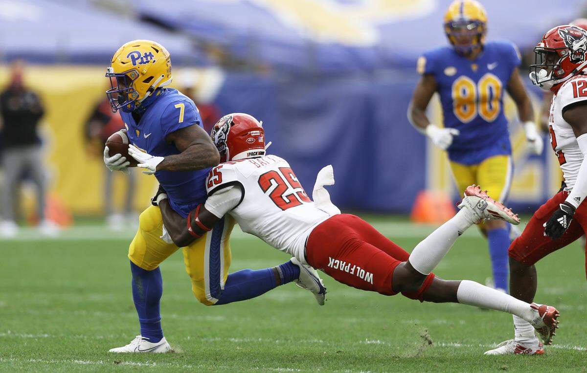 Pittsburgh Panthers wide receiver DJ Turner (7) tries to run as N.C. State’s Shyheim Battle (25) tackles him during the Wolfpack’s game against the Panthers at Heinz Field in Pittsburgh, PA, Saturday, Oct. 3, 2020.