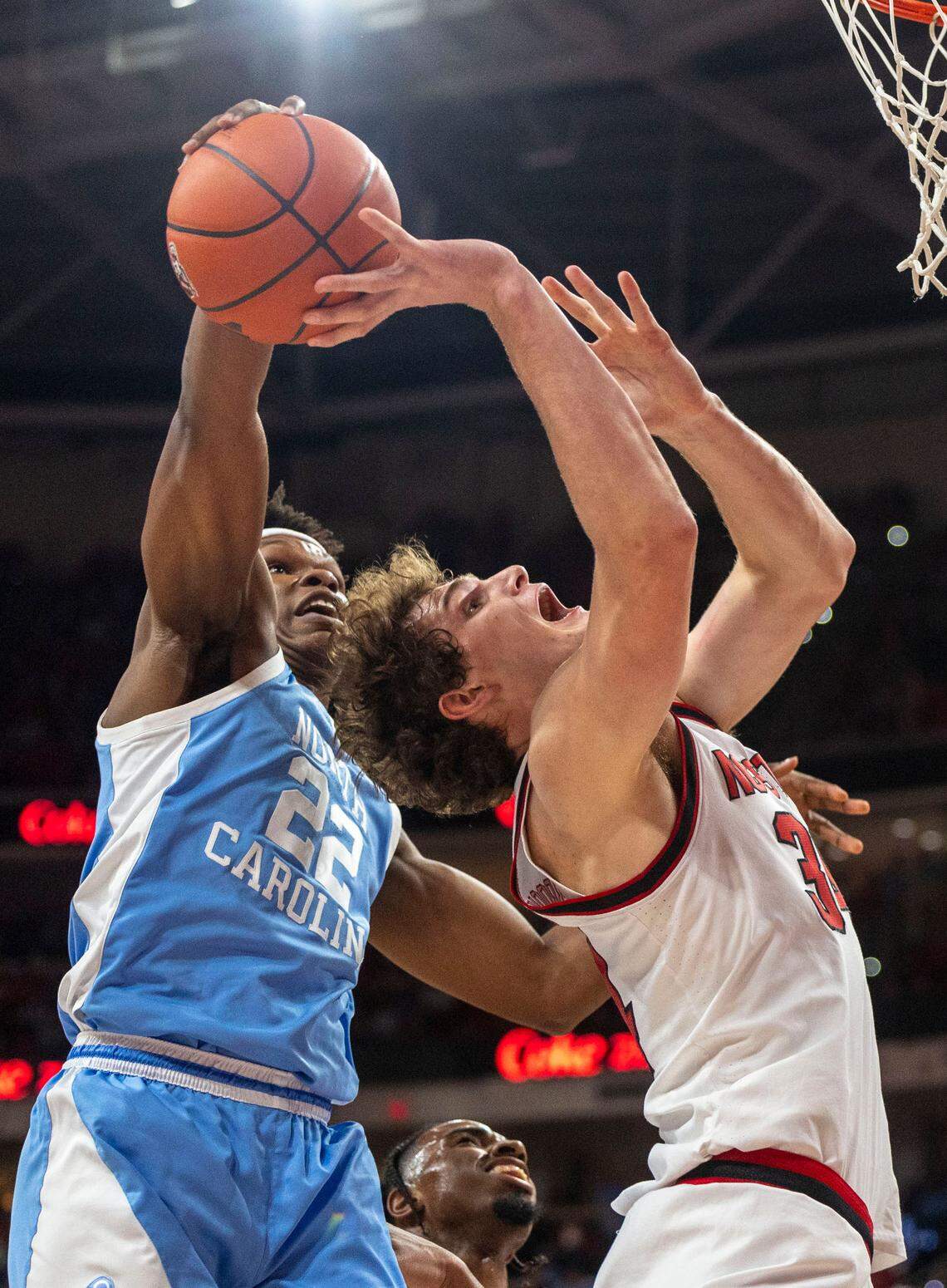 North Carolina forward Ven-Allen Lubin (22) blocks a shot by N.C. State’s Ben Middlebrooks (34) during the first half on Saturday, January 11, 2025 at Lenovo Center in Raleigh, N.C.