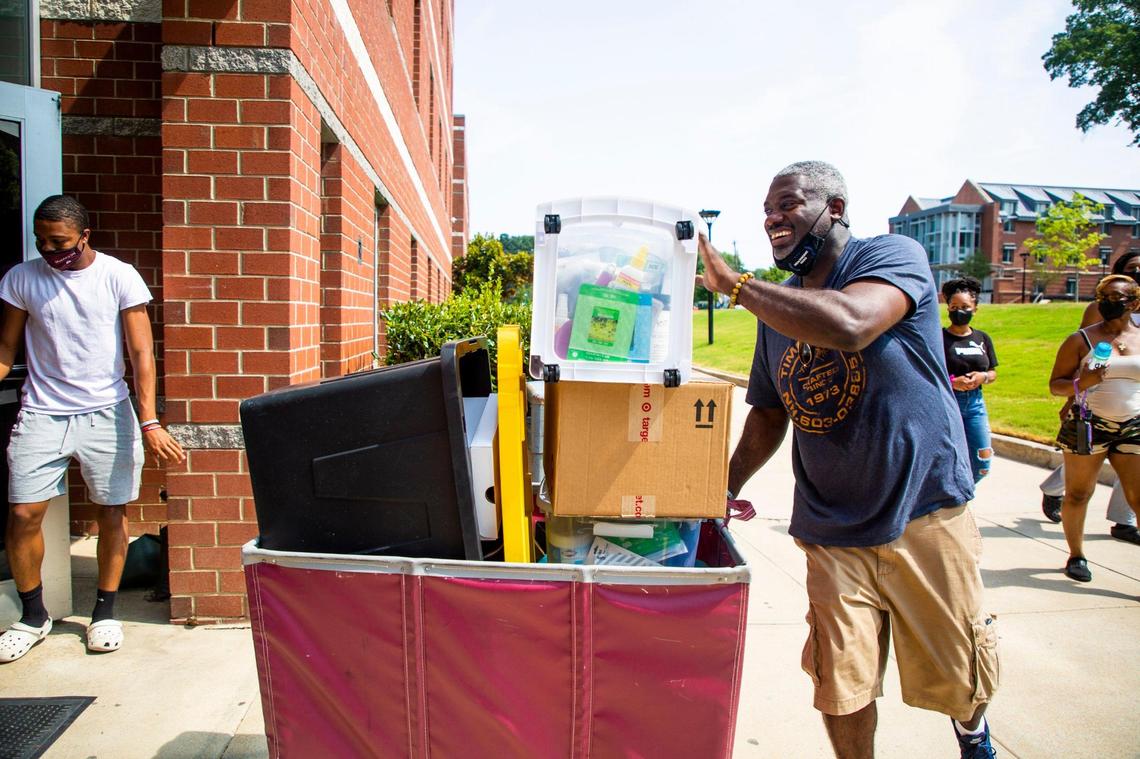 Norbert Robinson wheels in a cart of his daughter Niya Robinson’s belongings to her dorm for her freshman year at N.C. Central University, on Wednesday, Aug. 11, 2021, in Durham, N.C.
