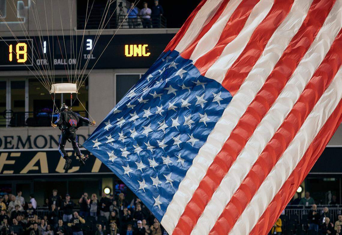 The American Flag is dropped into Truist Field by a skydiver during pre-game ceremonies prior to the North Carolina vs Wake Forest game on Saturday, November 12, 2022 at Truist Field in Winston-Salem, N.C.