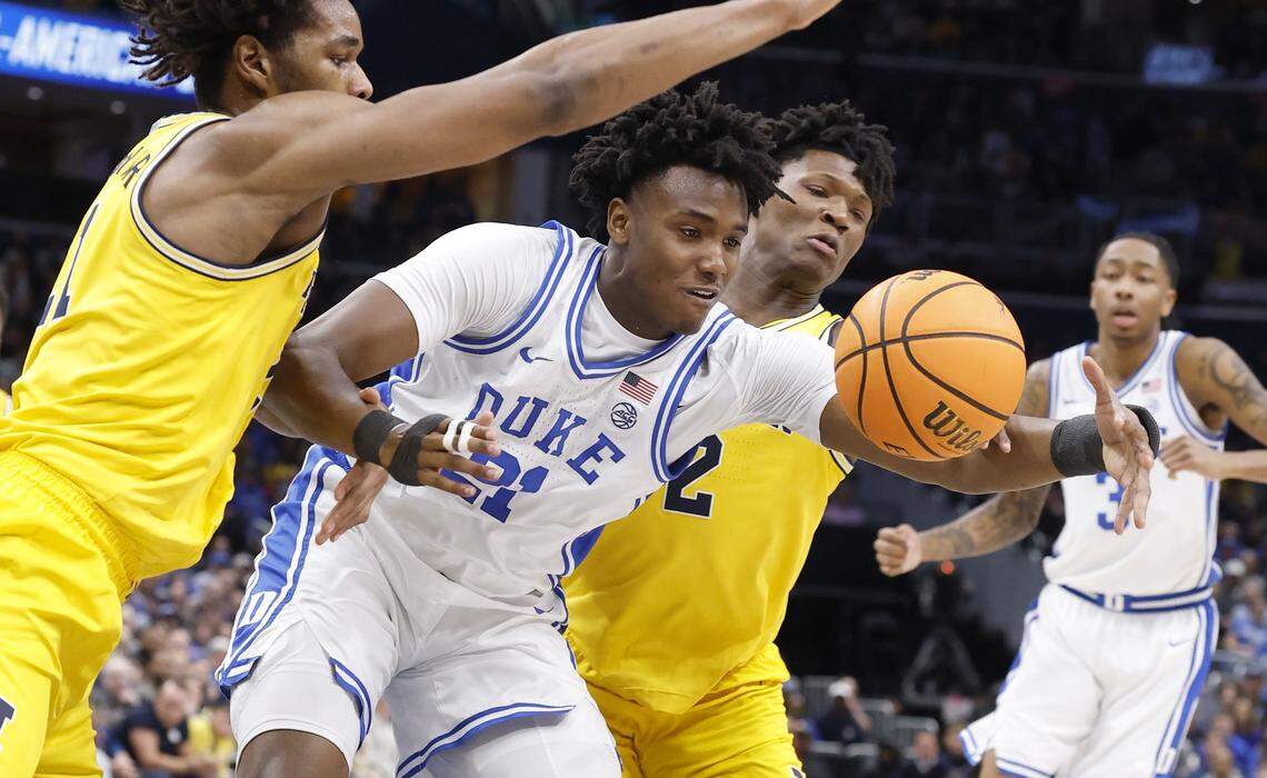 Duke’s Patrick Ngongba II (21) looses control of the ball while defended by Michigan's Morez Johnson Jr. (21) and L.J. Cason (2) during the first half of Duke’s game against Michigan in the Capital Showcase at Capital One Arena in Washington, D.C., Saturday, Feb. 21, 2026.