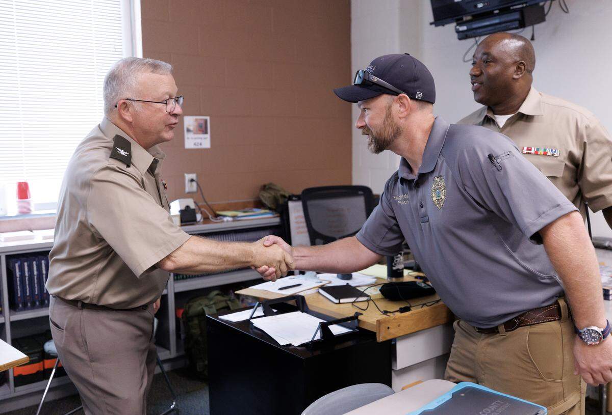 Knightdale Police Sgt. Rod Glahn, right, greets Col. Scot Storey, senior Army instructor for Knightdale Junior ROTC, during a visit to Knightdale High School on Wednesday, Aug. 13, 2025. Sgt. Glahn leads the Knightdale Police Department’s Community Resources Unit.