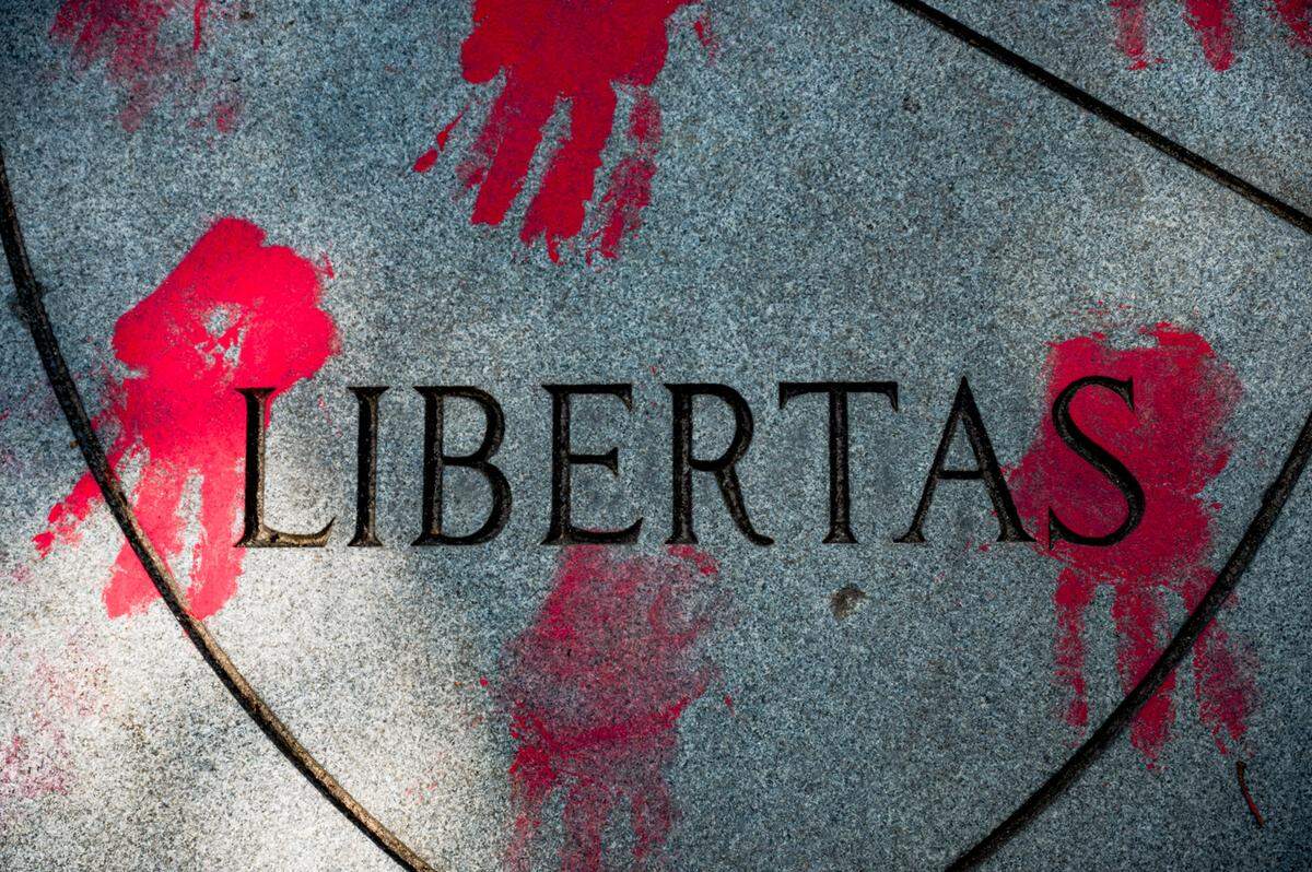 Protesters use red paint to leave handprints on the University of North Carolina Chapel Hill seal on Saturday, May 11, 2024.