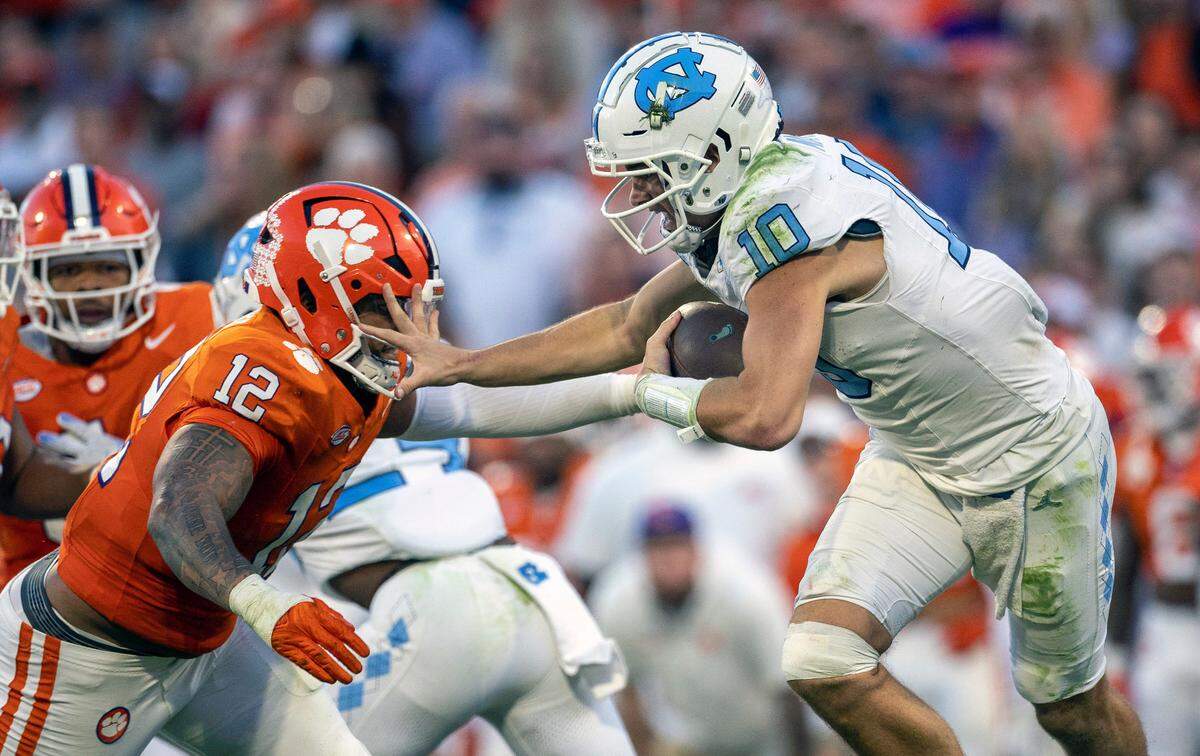 Clemson’s T.J. Parker (12) works to sack North Carolina quarterback Drake Maye (10) for an eight-yard loss in the second quarter on Saturday, November 18, 2023 at Memorial Stadium in Clemson, S.C.
