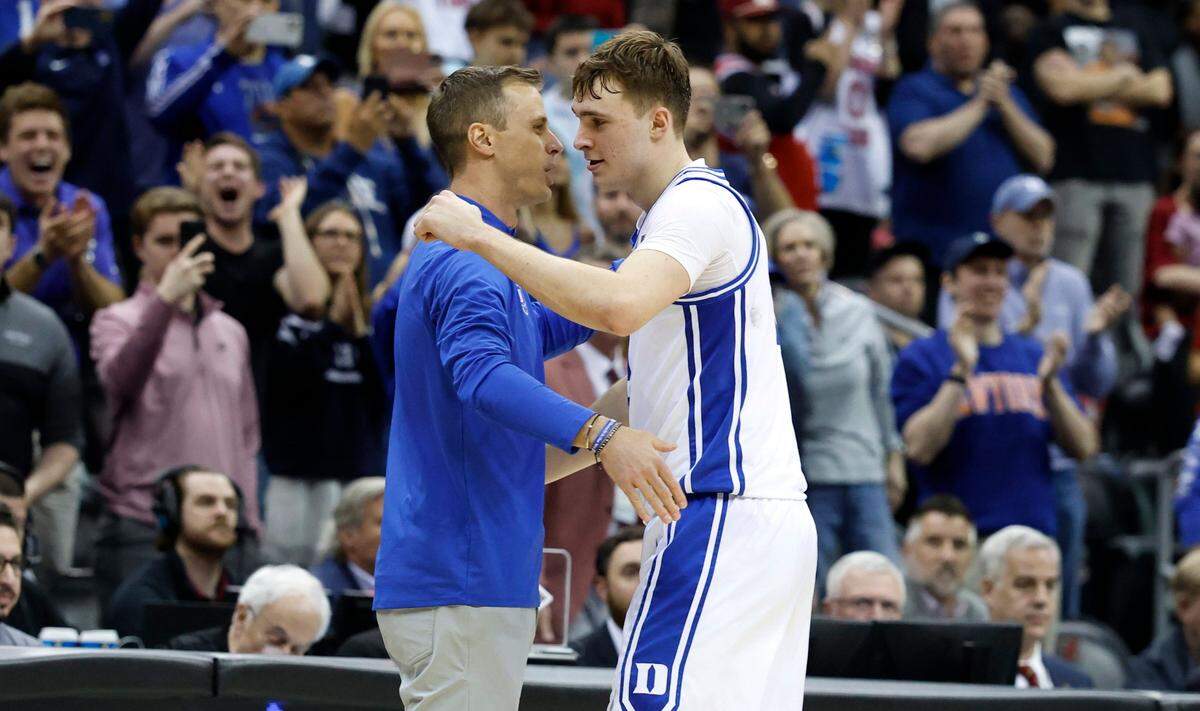 Duke’s head coach Jon Scheyer hugs Cooper Flagg (2) as time expires in Duke’s 85-65 victory over Alabama in their Elite 8 game in the 2025 NCAA Men’s Basketball Championship at the Prudential Center in Newark, N.J., Saturday, March 29, 2025.